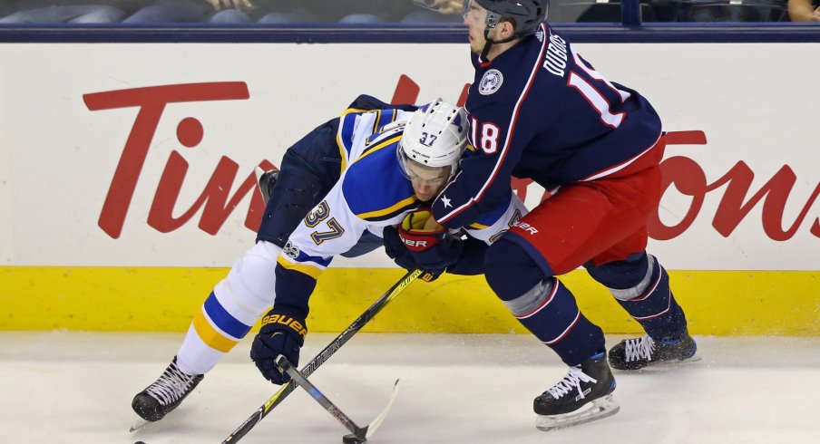 Pierre-Luc Dubois forces a St. Louis Blues player off of the puck