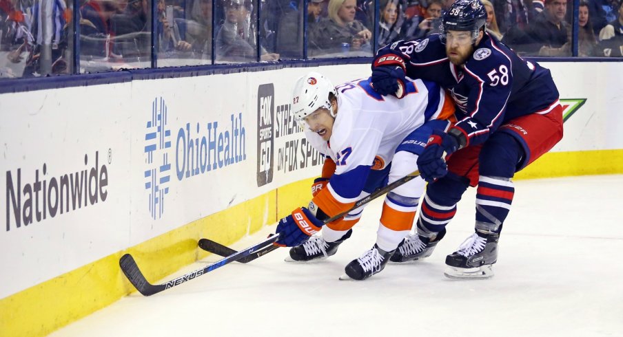 David Savard tries to push Anders Lee off of the puck at Nationwide Arena