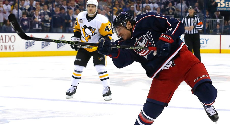 Cam Atkinson shoots a puck versus the Pittsburgh Penguins at Nationwide Arena