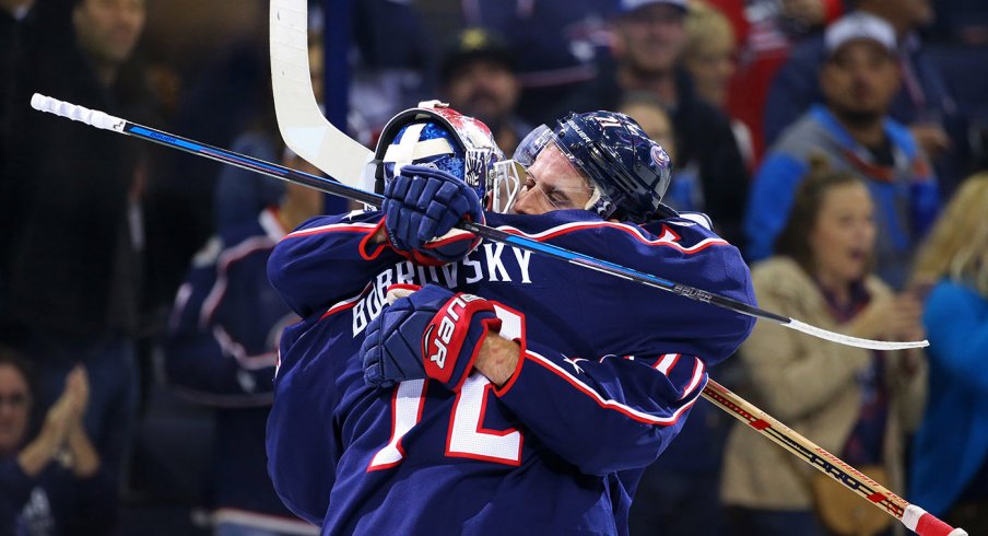 Sergei Bobrovsky and Nick Foligno hug following a win. 