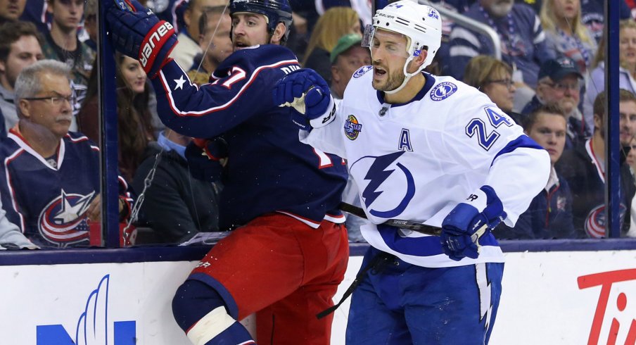 Brandon Dubinsky takes a hit along the boards during the Blue Jackets game against the Tampa Bay Lightning.