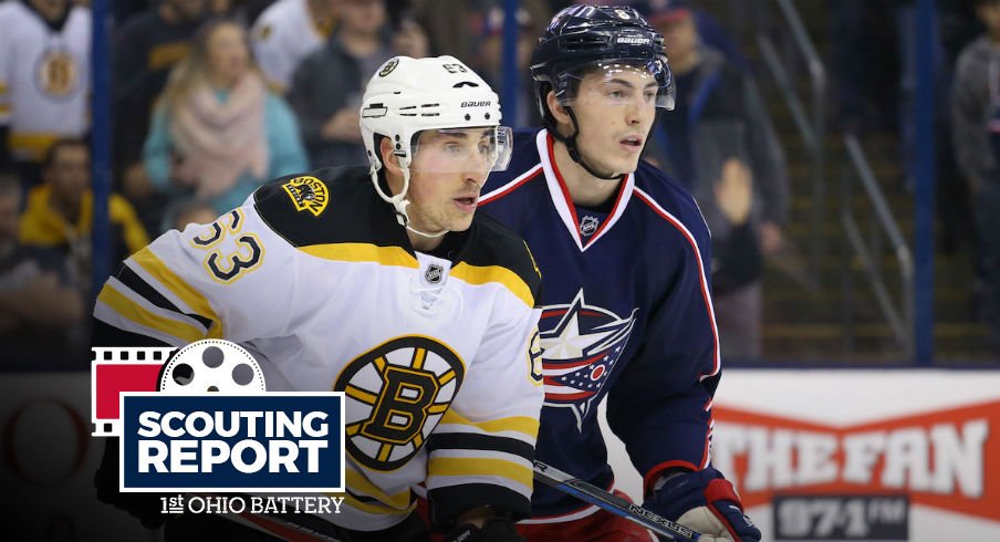 Blue Jackets defenseman Zach Werenski defends Boston Bruins forward Brad Marchand