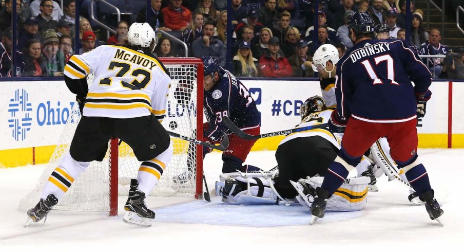 Boone Jenner and Brandon Dubinsky attack the Bruins net