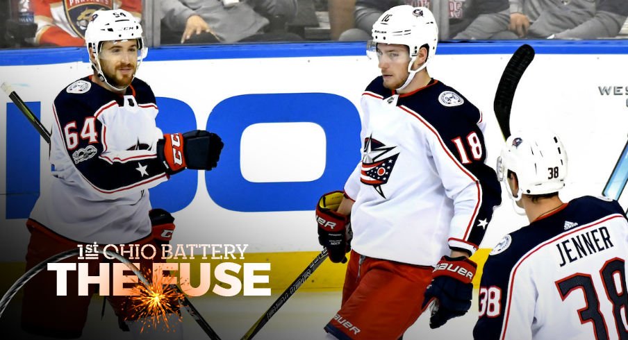 Tyler Motte celebrates a goal with Pierre-Luc Dubois and Boone Jenner