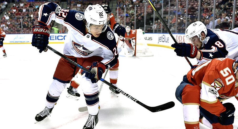 Sonny Milano retrieves a puck against the Florida Panthers