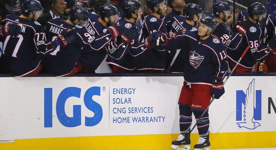 Cam Atkinson swings by the bench after scoring a goal