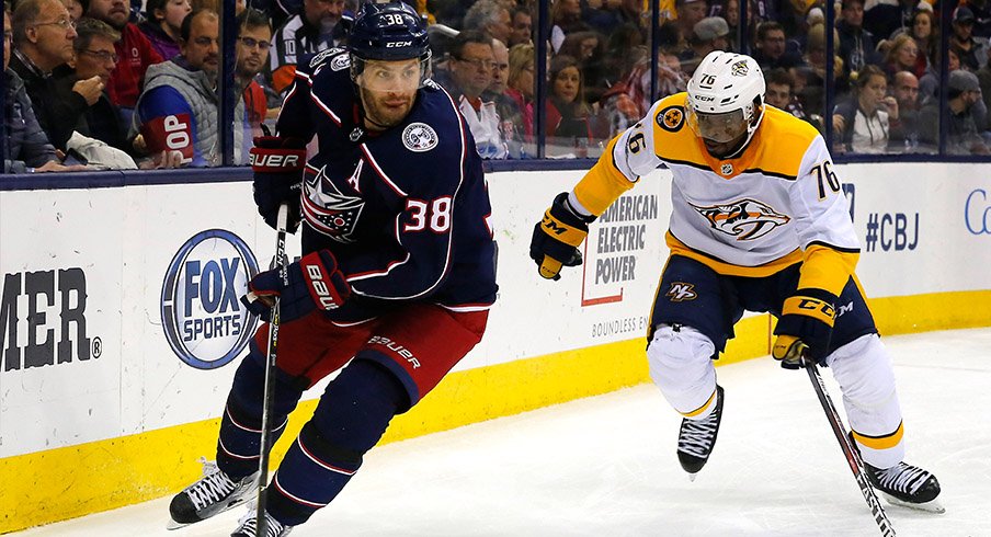 Boone Jenner skates past P.K. Subban of the Nashville Predators at Nationwide Arena.