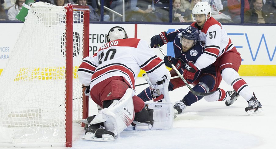 Oliver Bjorkstrand gets checked against the Carolina Hurricanes 