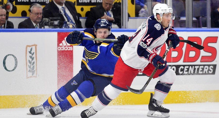 Jordan Schroeder gets tracked down by a St. Louis Blues player during the preseason