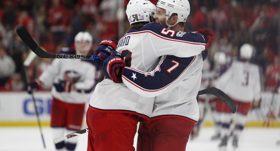 Jack Johnson and David Savard celebrate after Johnson scores the game-winning goal