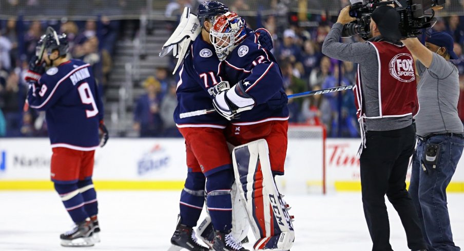 Sergei Bobrovsky and Nick Foligno embrace after a 1-0 overtime win over the Calgary Flames.