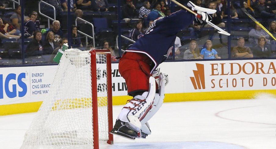 Sergei Bobrovsky jumps in the air to knock a puck down