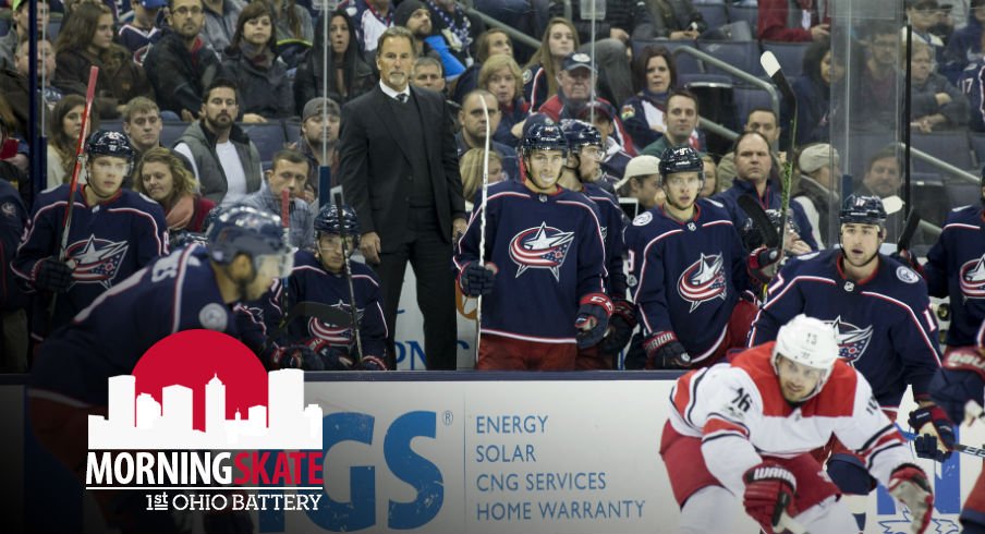 John Tortorella stands on the bench to overlook the play that is taking place