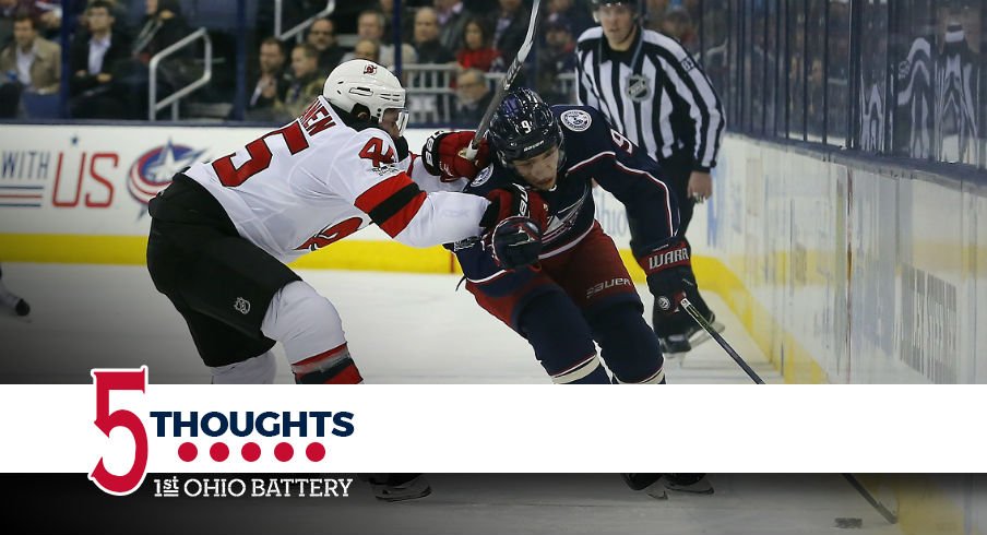 Artemi Panarin tries to get by a member of the New Jersey Devils