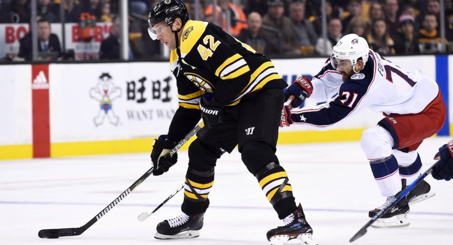 Blue Jackets forward Nick Foligno chases down Bruins forward David Backes