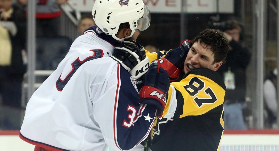 Sidney Crosby and Seth Jones throw punches at one another at the end of the second period.
