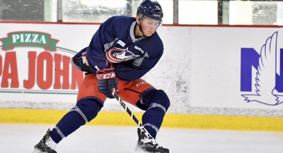 Robbie Stucker skates with the puck at Blue Jackets development camp