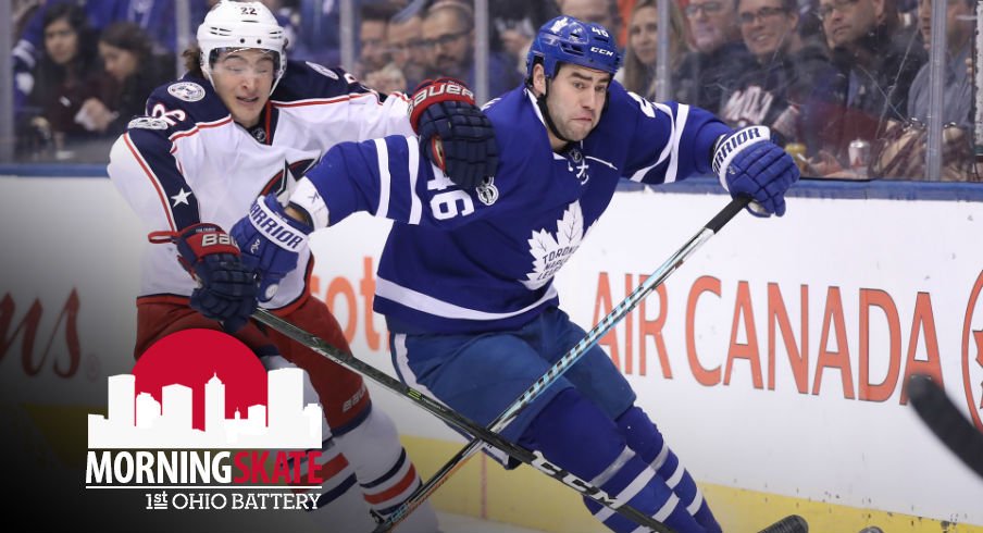 Sonny Milano tries to fight for the puck against Maple Leafs defenseman Roman Polak