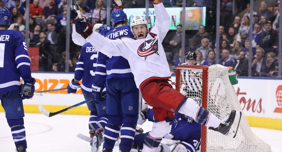 Boone Jenner celebrates Jordan Schroeder's goal to start the Blue Jackets comeback against the Leafs