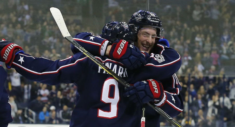 Pierre-Luc Dubois celebrates a goal with line mate Artemi Panarin