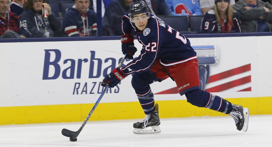 Sonny Milano skating down the ice looking for an open player