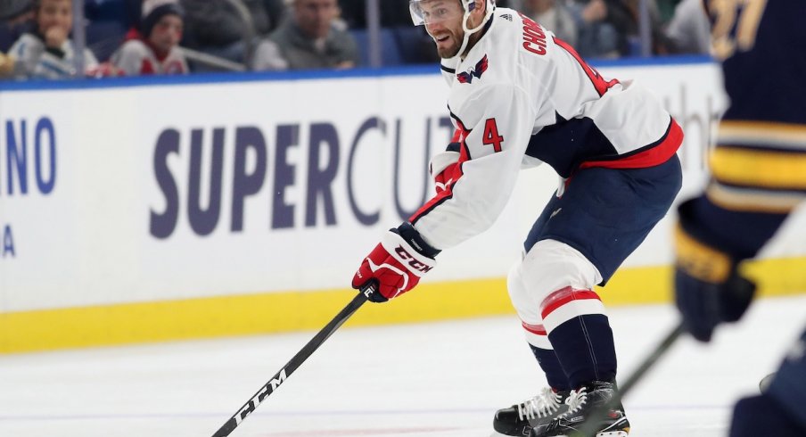 Taylor Chorney skates the puck up the ice against the Buffalo Sabres