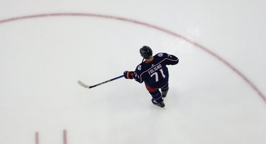 Nick Foligno stands alone on the ice during pre-game skate