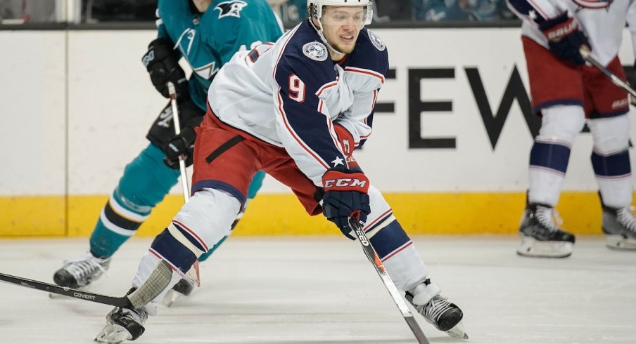 Artemi Panarin works with the puck and tries to find an open player