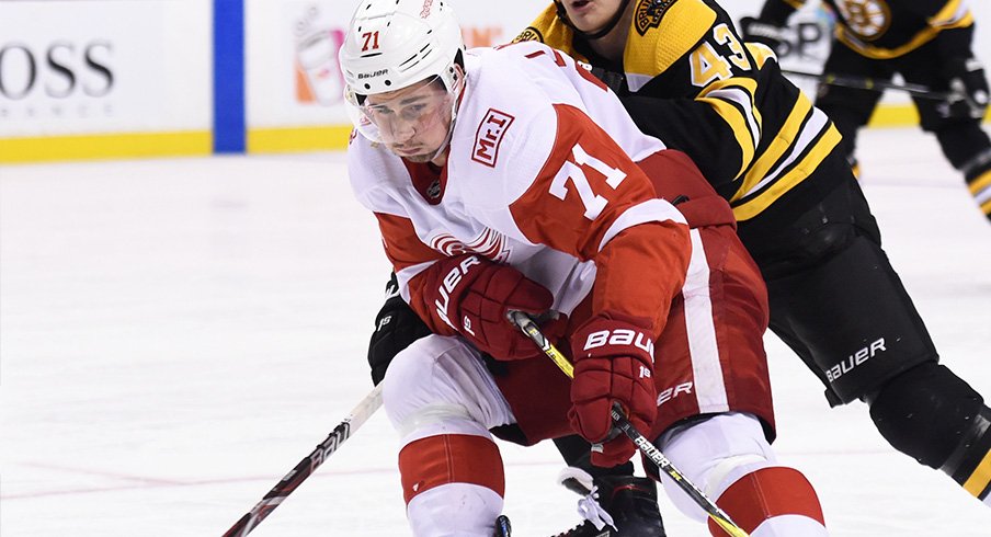 Dylan Larkin carries the puck against the Boston Bruins