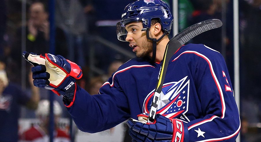 Seth Jones of the Columbus Blue Jackets points at someone who's not as good at hockey as he is. 
