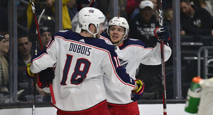 Pierre-Luc Dubois celebrates a goal with line mate Artemi Panarin