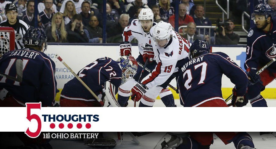 The Blue Jackets surround Sergei Bobrovsky in hopes of preventing a goal 