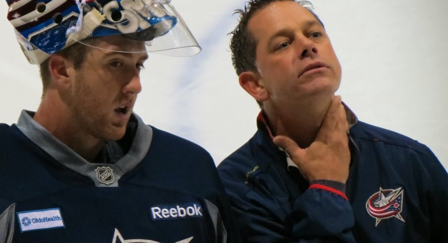 Ian Clark chats with goaltender Jeremy Smith during the Blue Jackets' development camp