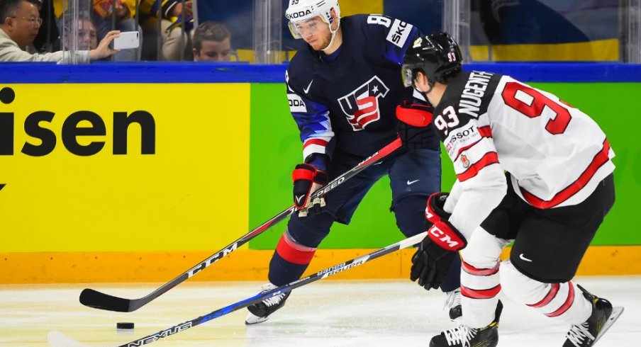 Cam Atkinson tries to out maneuver Ryan Nugent-Hopkins during the 2018 World Championship Bronze Medal game