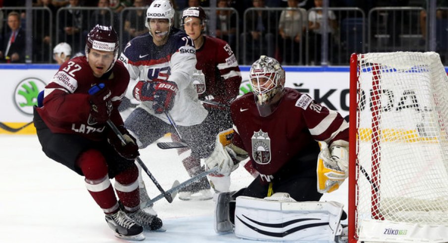 Elvis Merzlikins saves the puck for Latvia against Team USA