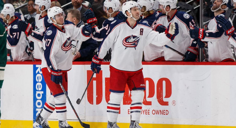 Blue Jackets defenseman Ryan Murray and forward Boone Jenner celebrate a goal with their teammates.