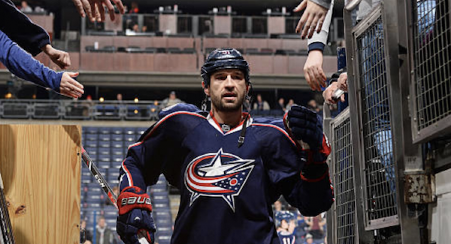 Fedor Tyutin greets fans as he exits the ice after warm-ups at Nationwide Arena.