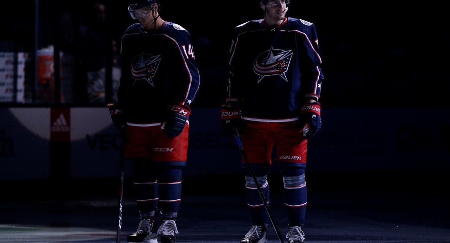 Pierre-Luc Dubois and Dean Kukan wait pregame for the national anthem.