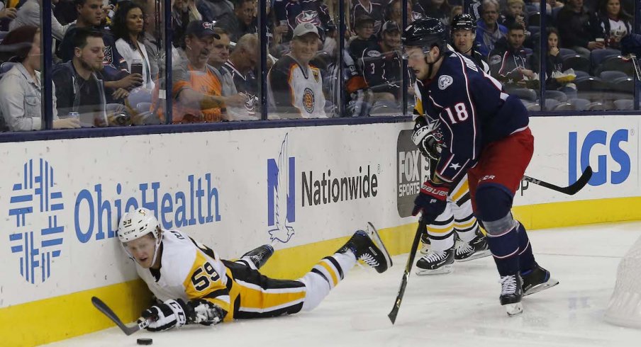 Columbus Blue Jackets center Pierre-Luc Dubois chases the puck behind the net in a game against the Pittsburgh Penguins at Nationwide Arena.