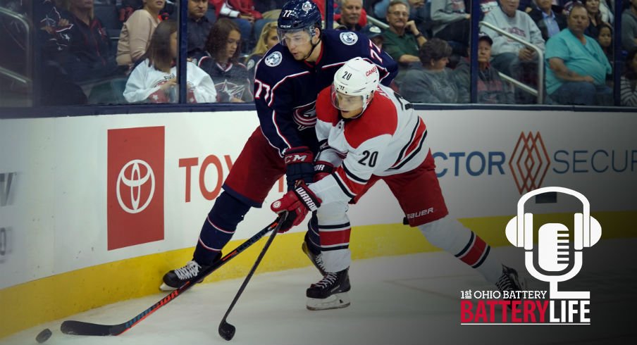 Josh Anderson and Sebastian Aho fight for the puck near the boards as they both try to gain possession