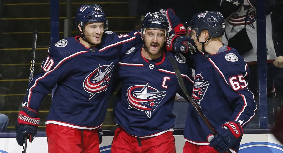 Nick Foligno celebrates his goal with Alexander Wennberg and Markus Nutivaara