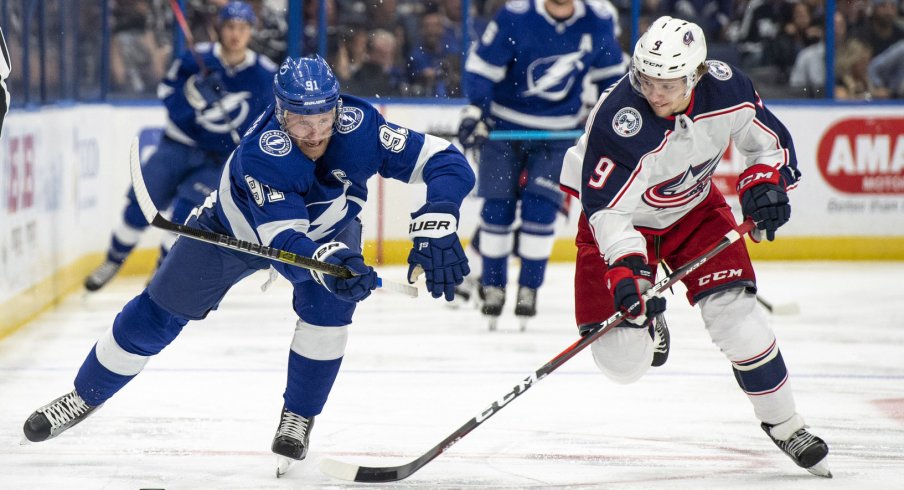 Artemi Panarin attempts to strip the puck from Steven Stamkos.