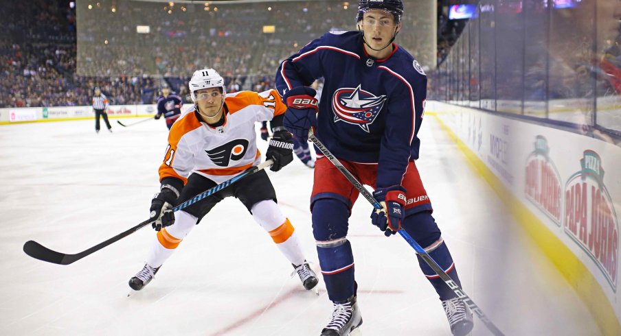 Columbus Blue Jackets defenseman Zach Werenski protects the puck against the Philadelphia Flyers at Nationwide Arena.