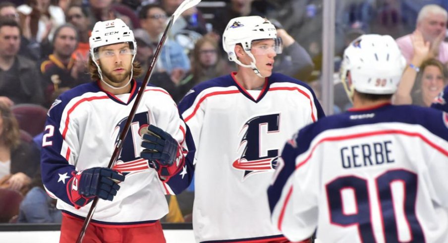 Kevin Stenlund, Nathan Gerbe and Ryan Collins celebrate a goal