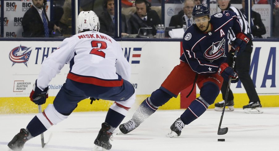 Seth Jones attempts to walk around Capitals defensemen Matt Niskanen