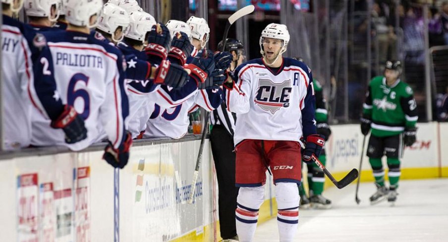 Trent Vogelhuber celebrates scoring a goal by fist bumping his teammates.