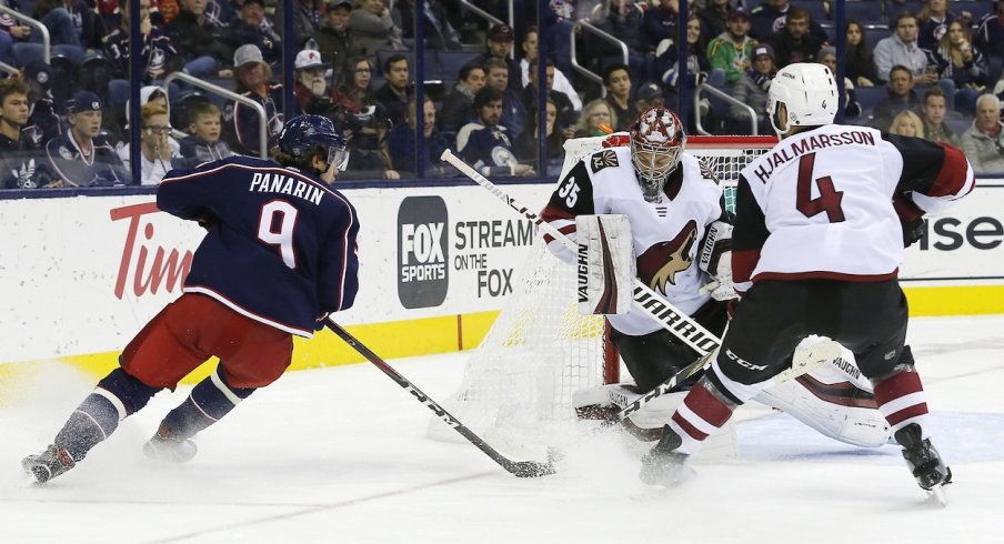 Artemi Panarin takes a shot on Coyotes goaltender Darcy Kuemper