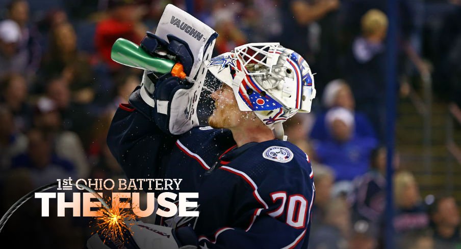 Columbus Blue Jackets goaltender Joonas Korpisalo hydrates during a stoppage in play at Nationwide Arena.
