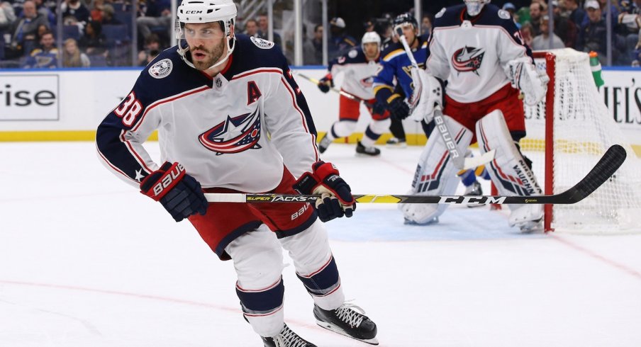 Boone Jenner goes after the puck in the defensive zone against the Blues.