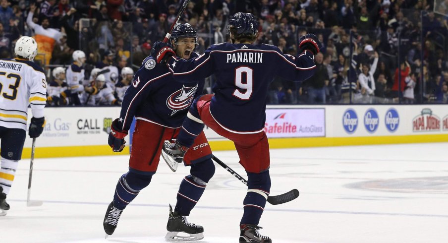 Artemi Panarin celebrates with Seth Jones after his overtime-winning goal against the Sabres on Saturday night.